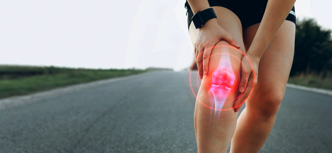 A woman holding her knee with an x-ray-style overlay.
