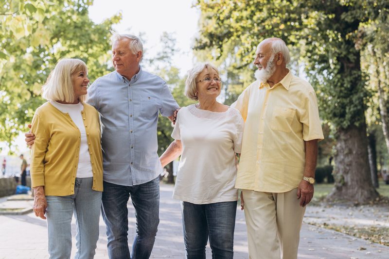 A senior couple walking together in the park.